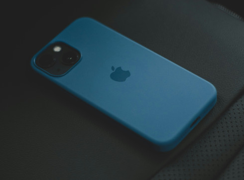a blue iphone sitting on top of a car seat